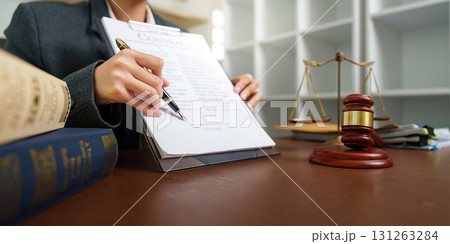 Lawyer Signing Important Legal Agreement in Office Lawyer Signing Important Legal Agreement in Office 131263284