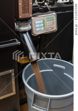 Roasted coffee beans just after roasting are fast poured from industrial roaster 131263380