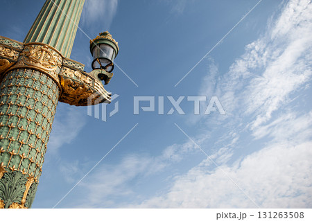 Monumental golden column and blue sky background 131263508