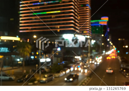 Blurred night seascape with moving cars on highway near illuminated buildings. Blurred night seascape with moving cars on highway near illuminated buildings. 131265769