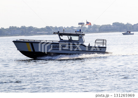 Harbor Patrol Boat Navigating Calm Waters in Islip During Daytime 131265969