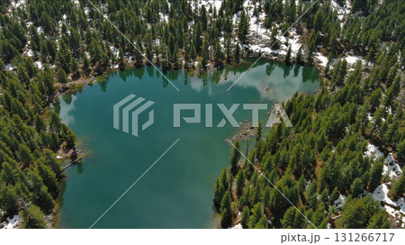 Mountain lake with snow mountains and green forest 131266717