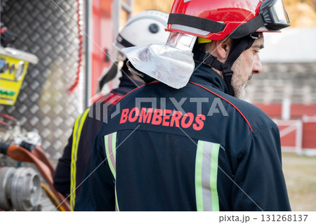 Firefighter check and maintenance equipment near fire truck.  131268137