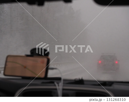 Defocus Through snow on asphalt road 131268310