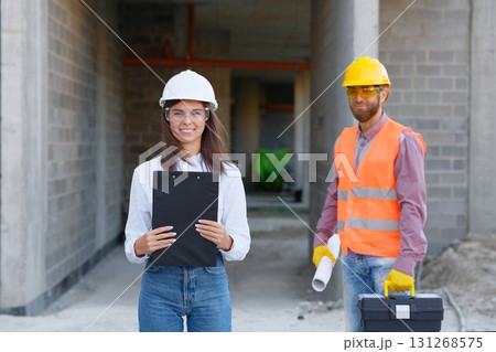 Construction engineers discussing building project at construction site Construction engineers discussing building project at construction site 131268575