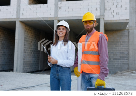 Construction workers wearing safety gear at building site 131268578
