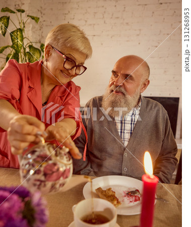 Elderly couple enjoying tea together in tender emotional family setting 131268953