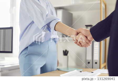 Close Up Of Businesswoman Shaking Hands With Client Or Colleague In Office Close Up Of Businesswoman Shaking Hands With Client Or Colleague In Office 131269041