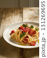 Spaghetti Pasta with Cherry Tomatoes and Basil on Rustic Wooden Table 131269695