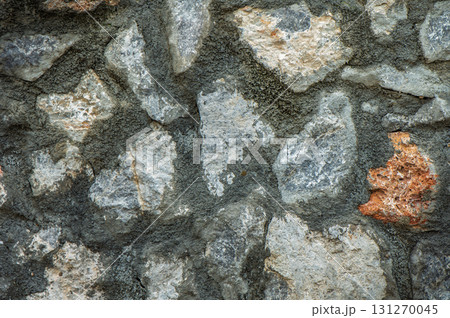 Natural textures and colors of a rustic stone wall in an ancient village setting during golden hour 131270045