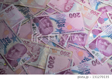 Stacks of colorful Turkish lira notes spread out on a table currency 131270135