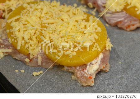 Baked chicken topped with pineapple and melted cheese ready for the oven 131270276