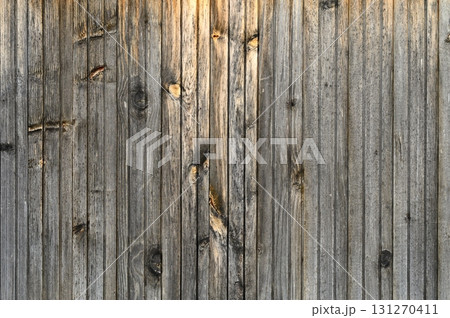 Weathered wooden wall exudes rustic charm and timeless beauty in soft evening light Weathered wooden wall exudes rustic charm and timeless beauty in soft evening light 131270411