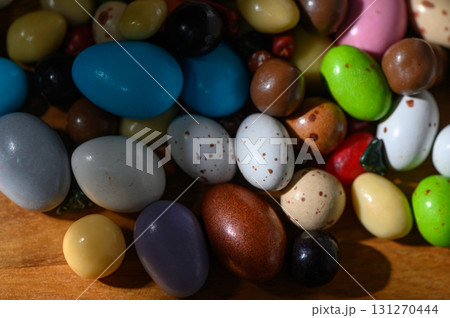 Colorful assortment of decorative eggs spread across a wooden surface during Colorful assortment of decorative eggs spread across a wooden surface during 131270444