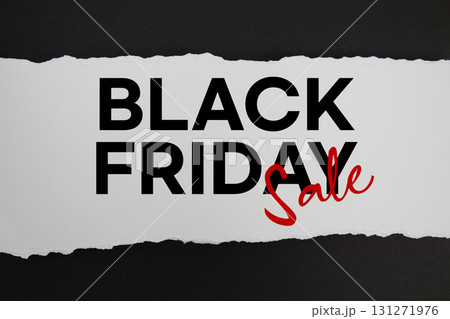 Black Friday Sale text on white paper torn ripped horizontal on black background 131271976