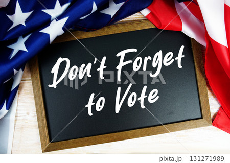American flag with blackboard "Don't Forget to Vote" on wooden background American flag with blackboard "Don't Forget to Vote" on wooden background 131271989