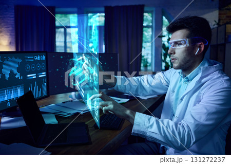Scientist wearing AR glasses interacting with futuristic AI interface and digital dashboards. Collage 131272237