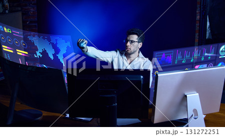 Analyst using holographic interface for global market data monitoring. Collage 131272251