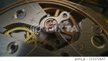 Macro Shot of Mechanical Clock Movement Showing Gears, Wheels and Balance Mechanism Macro Shot of Mechanical Clock Movement Showing Gears, Wheels and Balance Mechanism 131272647