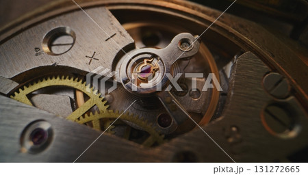 Macro Close Up Shot of Intricate Watch Mechanism with Moving Gears and Balance Wheel Macro Close Up Shot of Intricate Watch Mechanism with Moving Gears and Balance Wheel 131272665