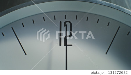 Macro Close Up Shot of Number 12 on the Dial and Running Second Hand on Minimalist Wall Clock 131272682