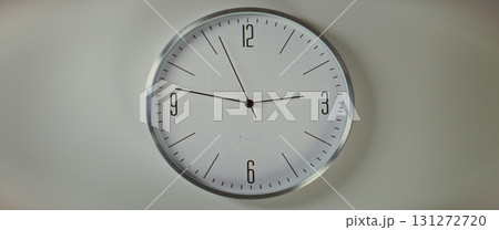 Close Up of Wall Clock with Minimalist Design Showing Precise Time, Hanging on the White Wall 131272720