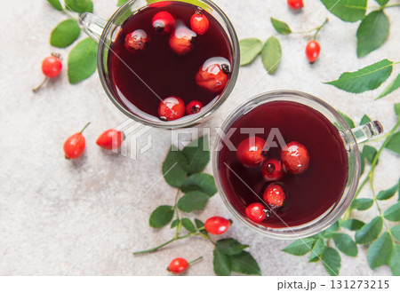 Drinking hot rosehip tea with berries and leaves 131273215