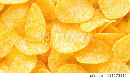 Salted potato chips surface with crunchy snack texture Salted potato chips surface with crunchy snack texture 131273312