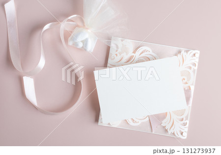 White wedding luxury invitation card mockup 7x5 on pastel pink background with envelop and flavor White wedding luxury invitation card mockup 7x5 on pastel pink background with envelop and flavor 131273937