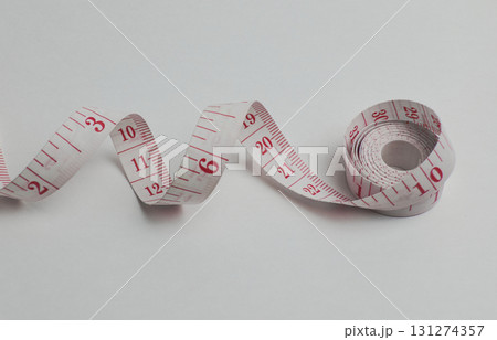 A measuring tape is displayed on a white A measuring tape is displayed on a white 131274357