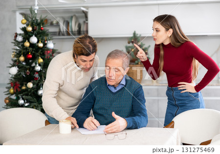 Adult children argue with each other and show their mature father how to fill out documents correctly Adult children argue with each other and show their mature father how to fill out documents correctly 131275469