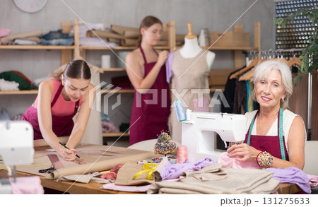 team of female seamstresses works in the atelier 131275633