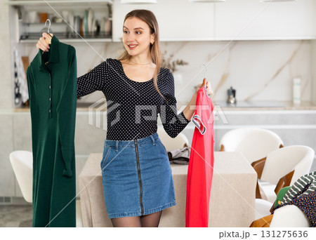Young woman choosing which dress to wear 131275636