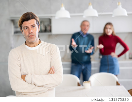 Father and wife scold an man. He doesnt want to talk to them. Family quarrel 131275820