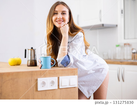 Woman drinking coffee at kitchen in morning Woman drinking coffee at kitchen in morning 131275830
