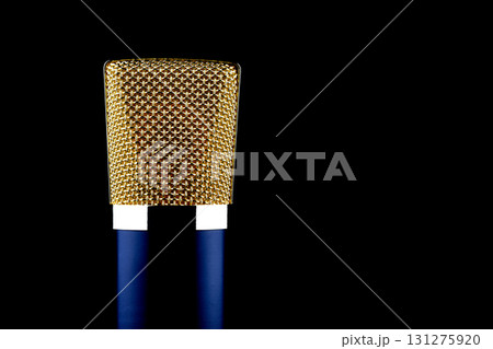 Closeup View of Blue and Gold Microphone Isolated on a Black Background Closeup View of Blue and Gold Microphone Isolated on a Black Background 131275920