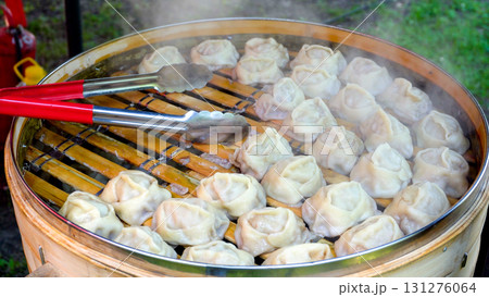 Cooking manti. A traditional Central Asian dish. Street food. 131276064