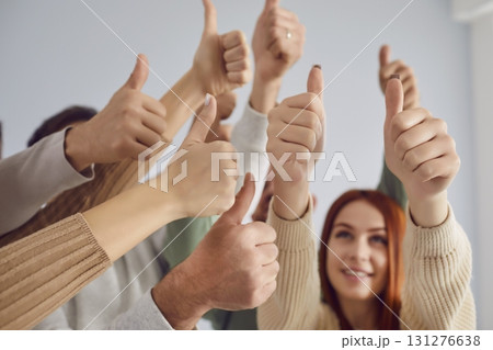 Thumb up gesture of approval or encouragement, young people group raising thumb showing agreement Thumb up gesture of approval or encouragement, young people group raising thumb showing agreement 131276638