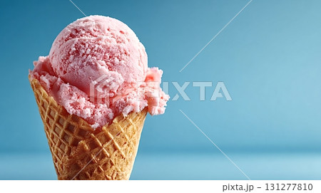Delicious pink ice cream melting in waffle cone on blue background 131277810