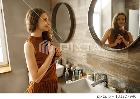 An Elegant Woman Posing in a Stylishly Designed Bathroom Setting with Various Accessories 131277940