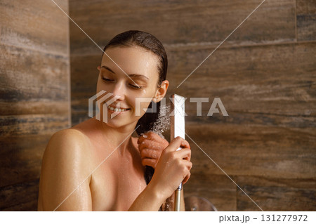 A Woman Enjoying a Truly Relaxing and Rejuvenating Shower Experience in Her Bathroom Space 131277972