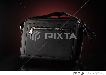 black bag mockup features a stylish design with a zipper pocket and an adjustable strap perfect for various uses. The sleek shape highlights modern fashion trends. black bag mockup features a stylish design with a zipper pocket and an adjustable strap perfect for various uses. The sleek shape highlights modern fashion trends. 131278460