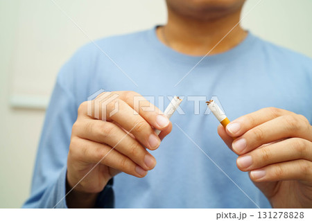 Quit smoking, Asian man breaking destroy cigarette in hand. Quit smoking, Asian man breaking destroy cigarette in hand. 131278828