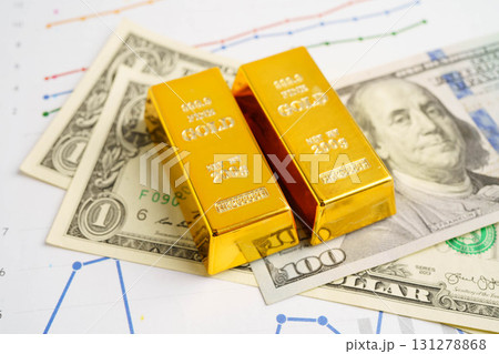 Gold bars on graph paper, finance trading investment business currency. Gold bars on graph paper, finance trading investment business currency. 131278868