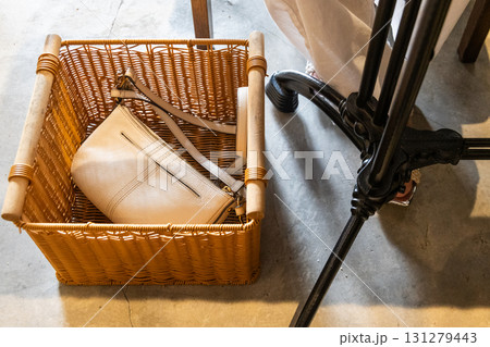 Close-up on handbag storage basket at restaurant for diners to place handbag for space and convenience. 131279443