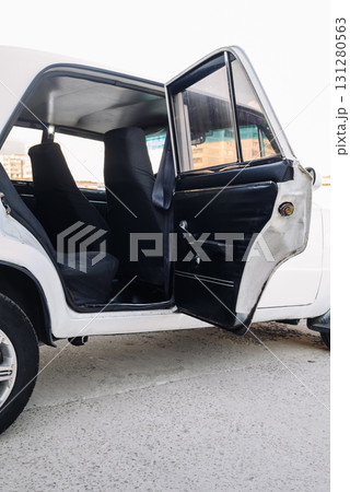 side view of a white retro sedan with an open rear door, passenger compartment 131280563