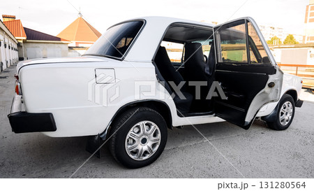 side view of a white retro sedan with an open rear door, transport concept 131280564