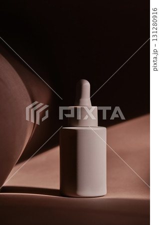 A bottle of face serum on a brown chocolate background. 131280916