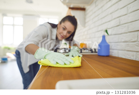 Female cleaner kitchen cloth polishing, happy housewife, professional janitor service Female cleaner kitchen cloth polishing, happy housewife, professional janitor service 131281036