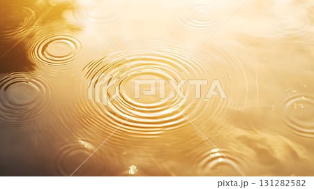 raindrop circles forming ripples on water golden sunlight raindrop circles forming ripples on water golden sunlight 131282582